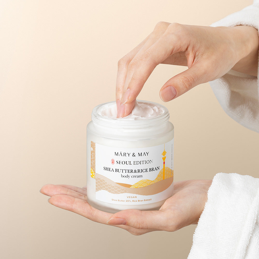 Indulge in the luxurious Mary&May Shea Butter & Rice Bran Body Cream, crafted in South Korea to nourish and elevate your skincare ritual with exquisite ingredients.