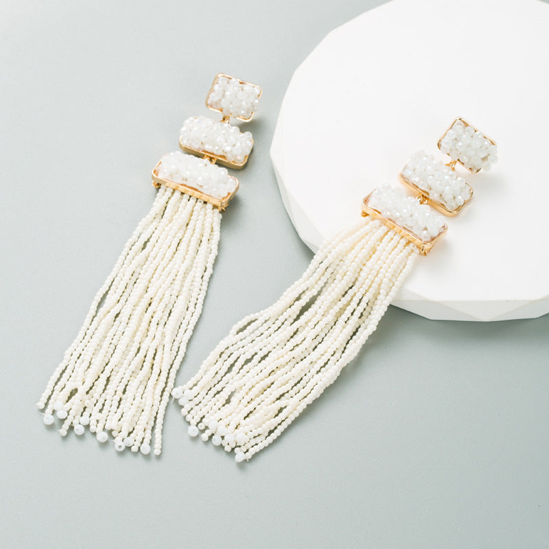 Discover athé's Exquisite Long Bohemian Rice Bead Earrings, handcrafted in South Korea, blending luxurious gold-plated metal and rice beads for timeless elegance.