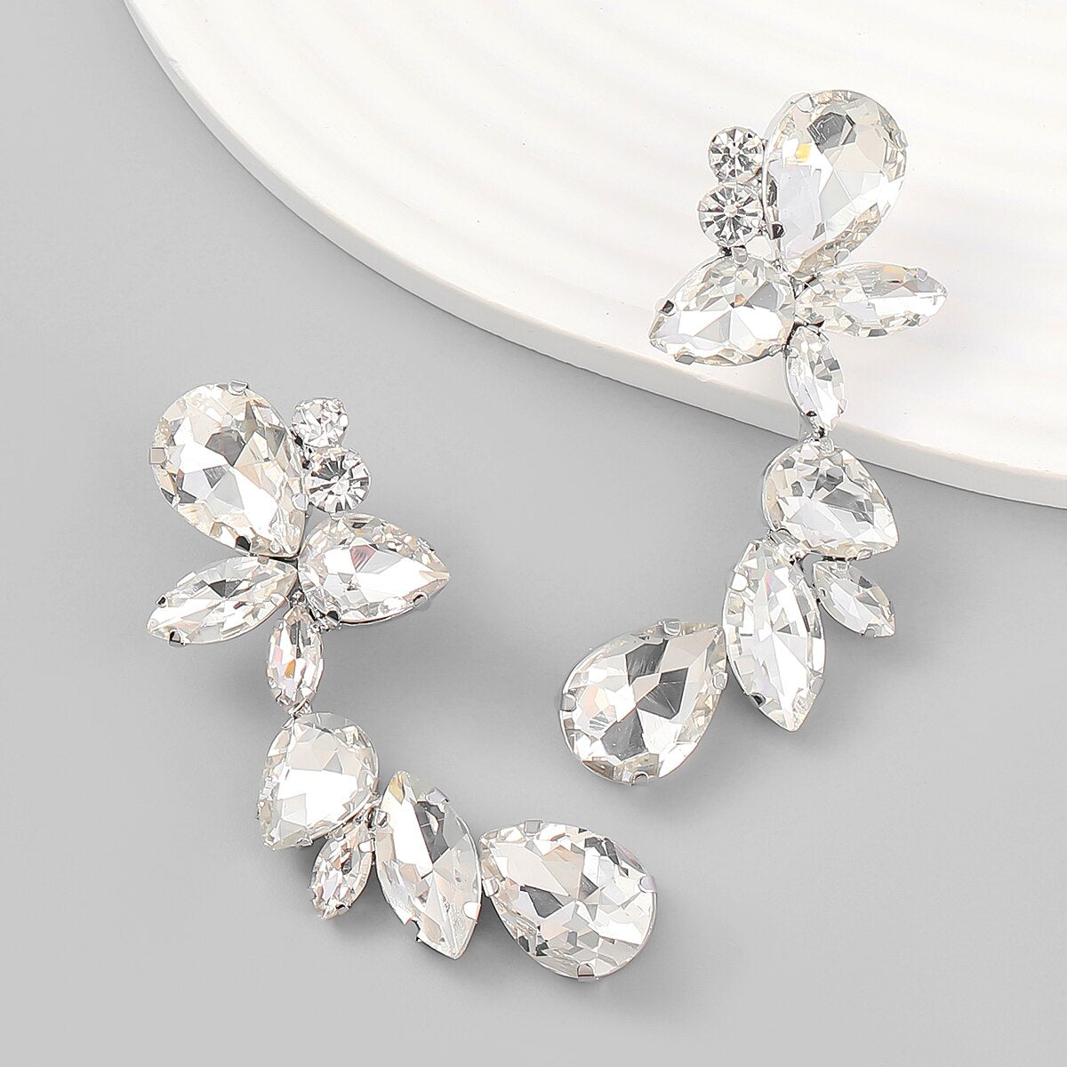 Experience the exquisite craftsmanship of athé's Floral Dangle Rhinestone Earrings, a South Korean luxury piece that elevates your elegance for any occasion.