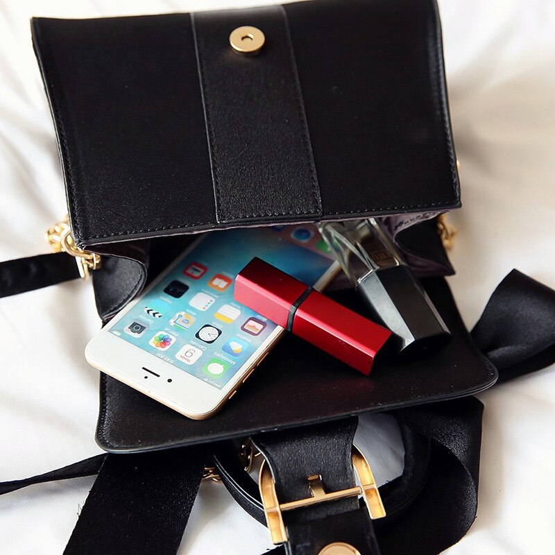 Discover athé's Velvet Bow-Accent Top-Handle Handbag, a South Korean masterpiece of luxurious velvet and exquisite craftsmanship, perfect for elevating any elegant occasion.